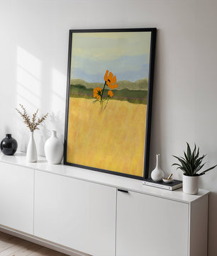 Orange Flowers in a Golden Field with Mountains and Blue Sky