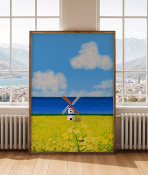 Paisaje pintoresco con molino de viento en un campo floreciente junto al mar