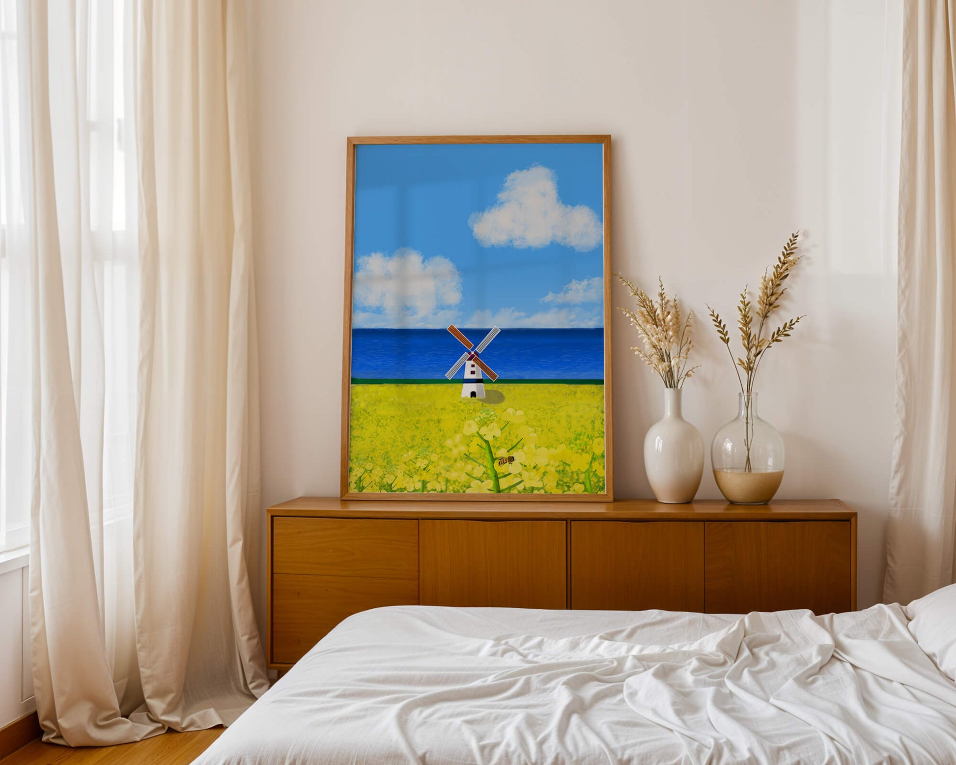 Scenic landscape with windmill in blooming field by the sea