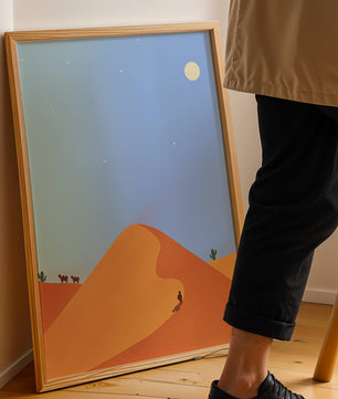 Serene desert landscape with dunes, camels, and a lone traveler under a starry sky
