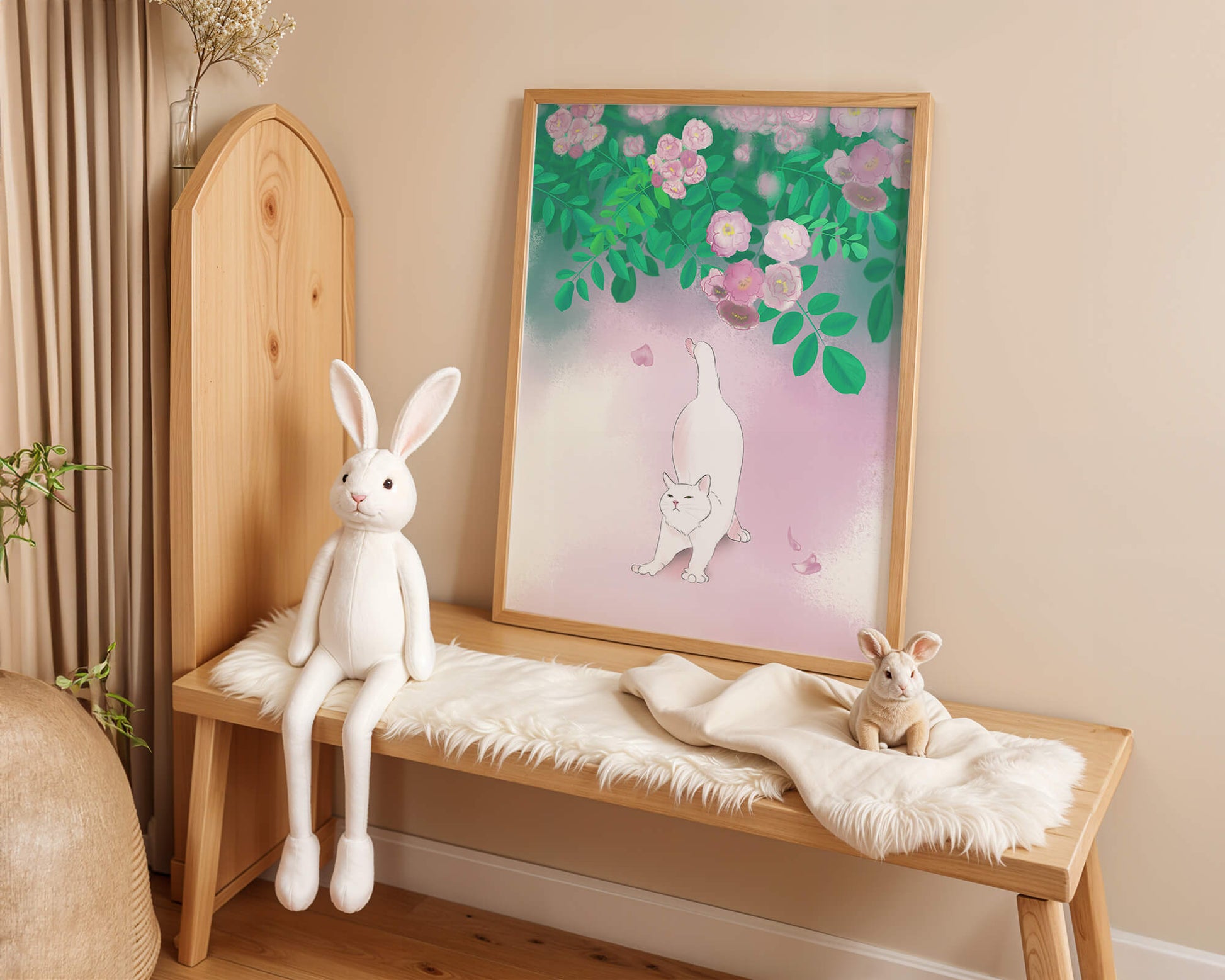 White cat stretching beneath blooming flowers in a pastel garden setting