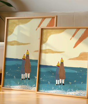 Two figures in winter clothing on a serene beach