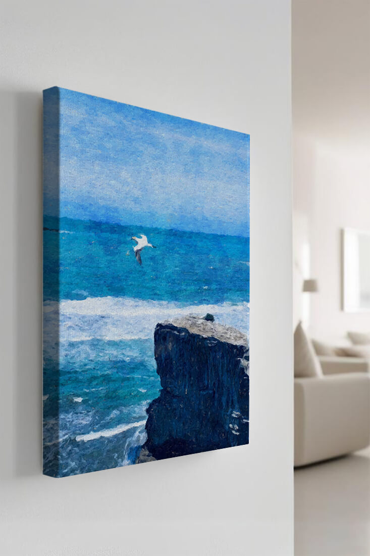 Seascape with soaring seagull over rocky cliff and ocean waves