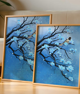 Bird on a branch with blue flowers against a snowy background