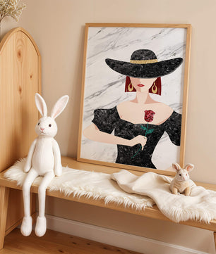 Elegant woman in wide-brimmed hat holding a rose on marble background