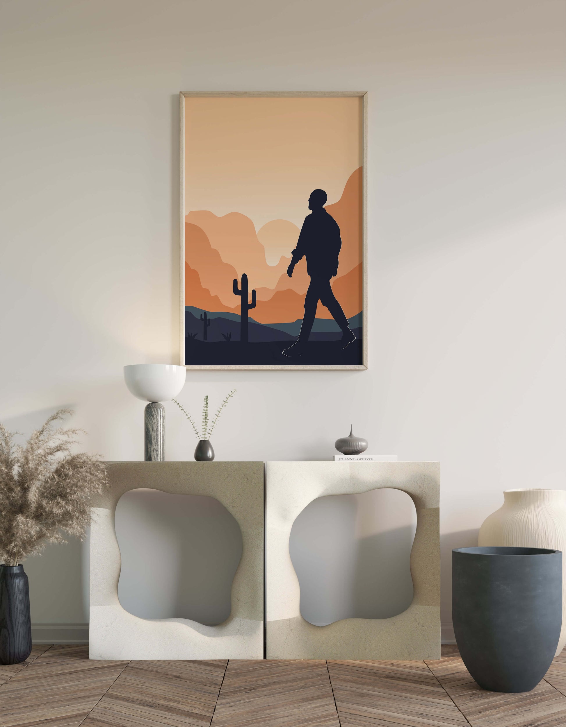 Silhouetted figure walking in desert landscape at sunset