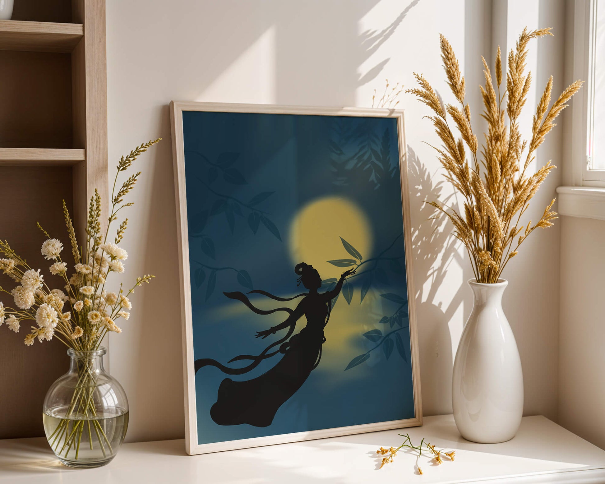 Silhouette of a Woman Reaching for Leaves in Front of a Full Moon