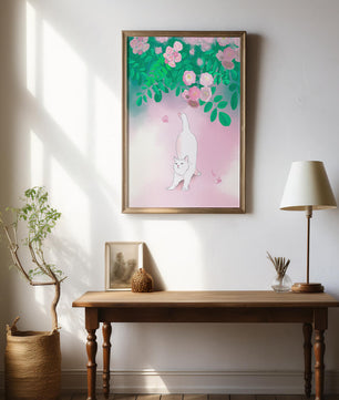 White cat stretching beneath blooming flowers in a pastel garden setting
