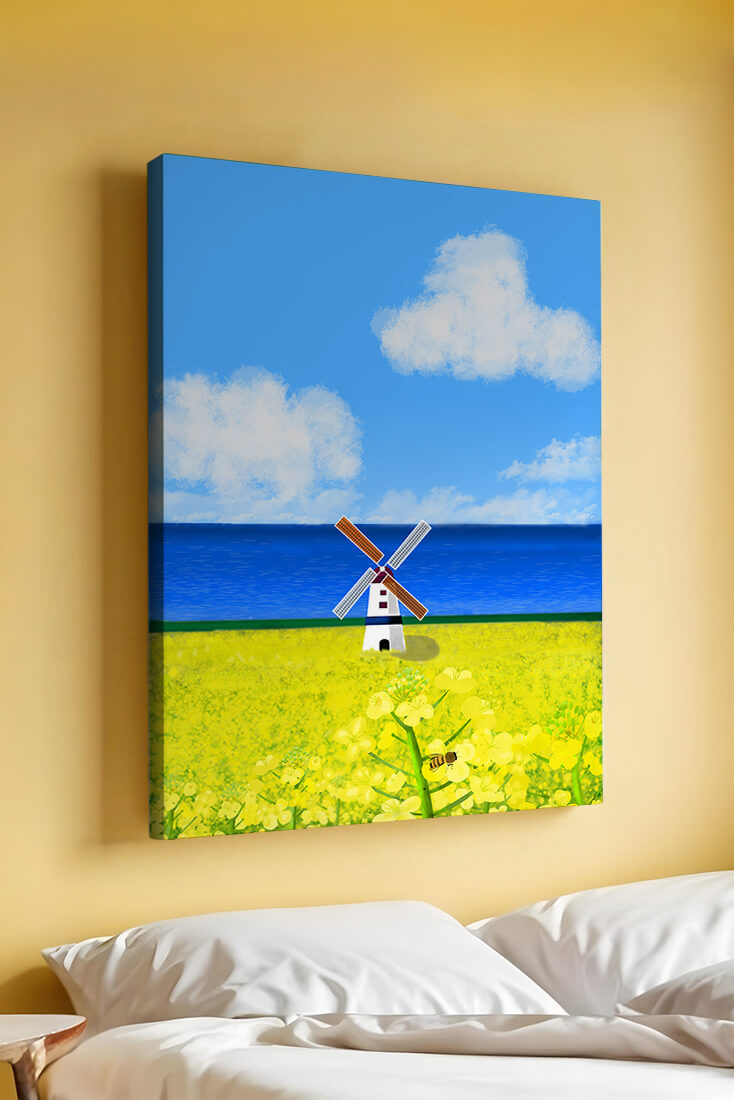 Scenic landscape with windmill in blooming field by the sea