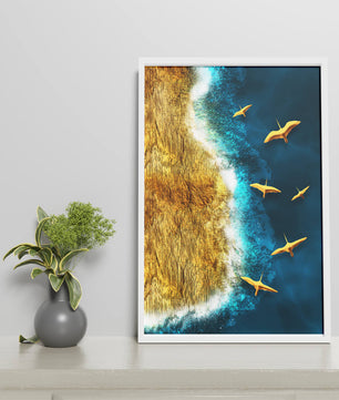 Golden beach landscape with vibrant ocean and flying seabirds