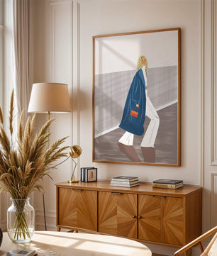 Fashionable Woman in Long Blue Coat Walking Along Corridor with Orange Handbag
