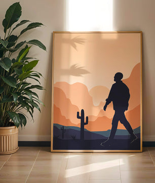 Silhouetted figure walking in desert landscape at sunset