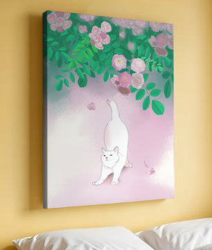 White cat stretching beneath blooming flowers in a pastel garden setting