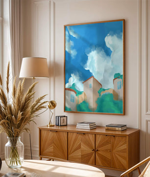 Serene landscape with houses and fluffy clouds against a blue sky