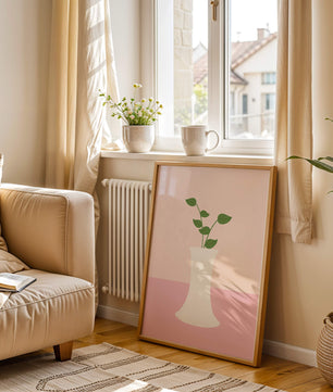 Simple Minimalist Illustration of a White Vase with Green Leaves on a Pink Background - Mi tienda