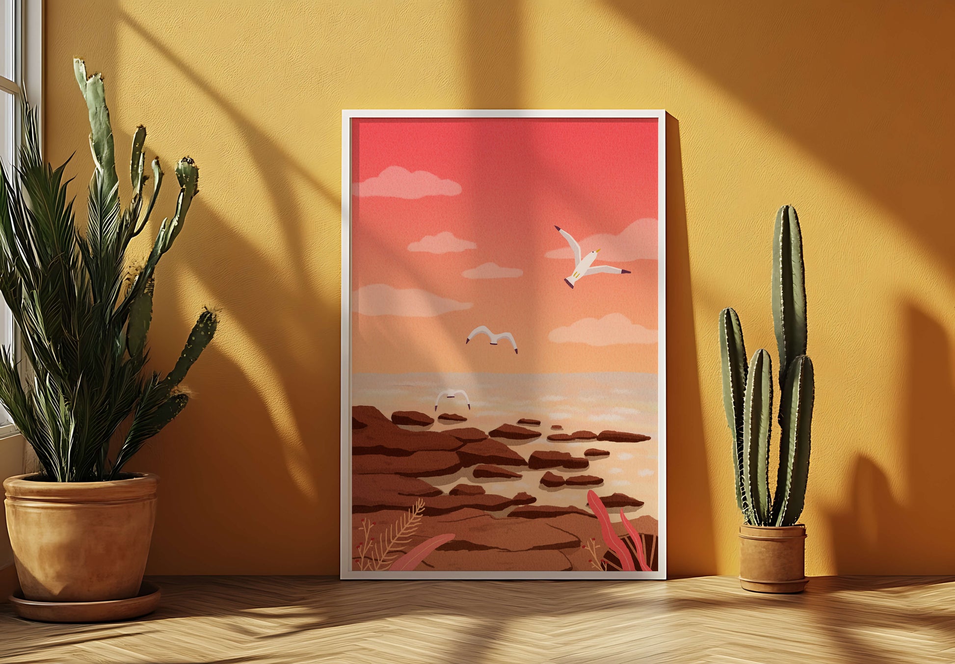 Seagulls flying over rocky coastline at sunset
