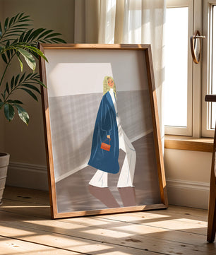 Fashionable Woman in Long Blue Coat Walking Along Corridor with Orange Handbag