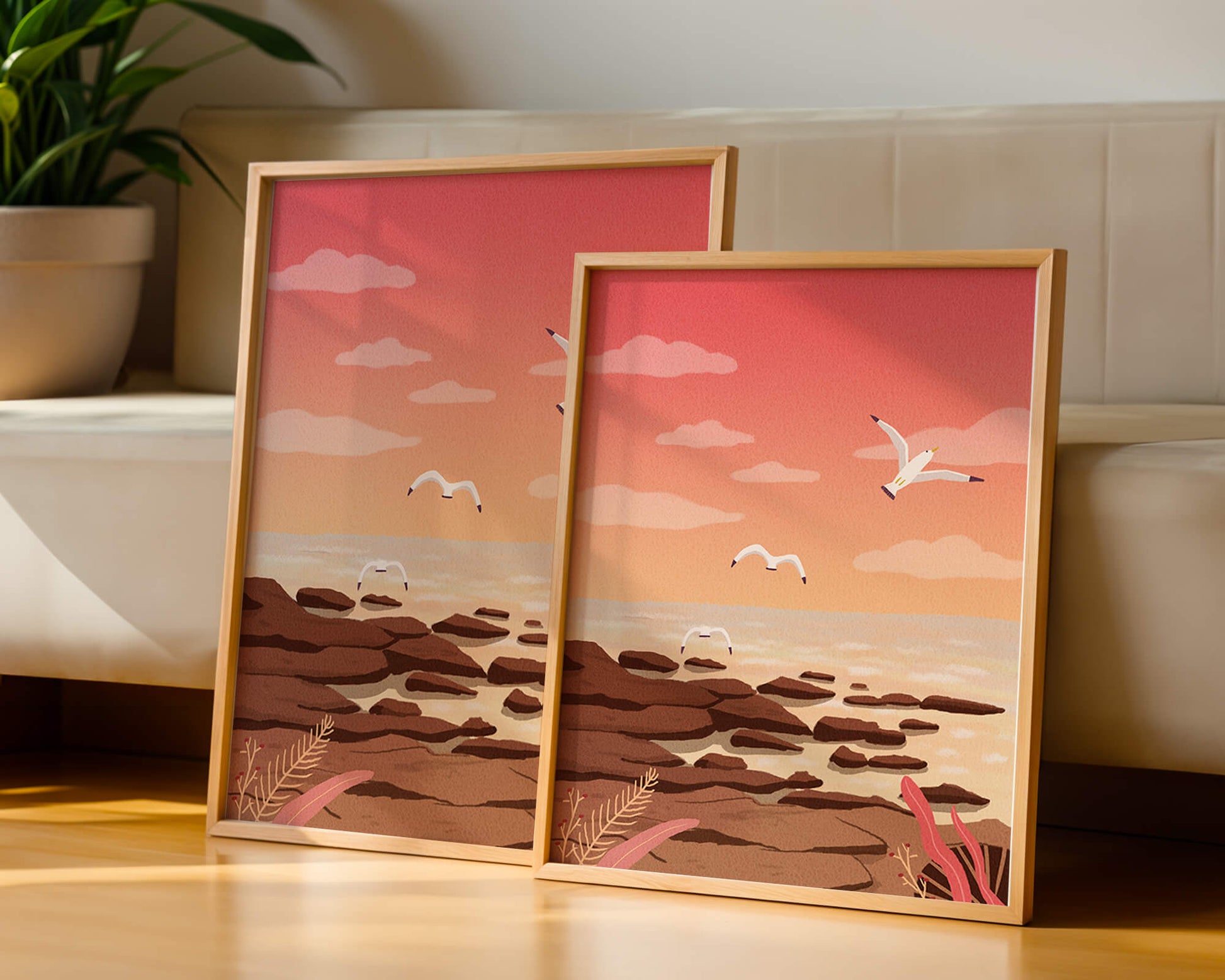Seagulls flying over rocky coastline at sunset