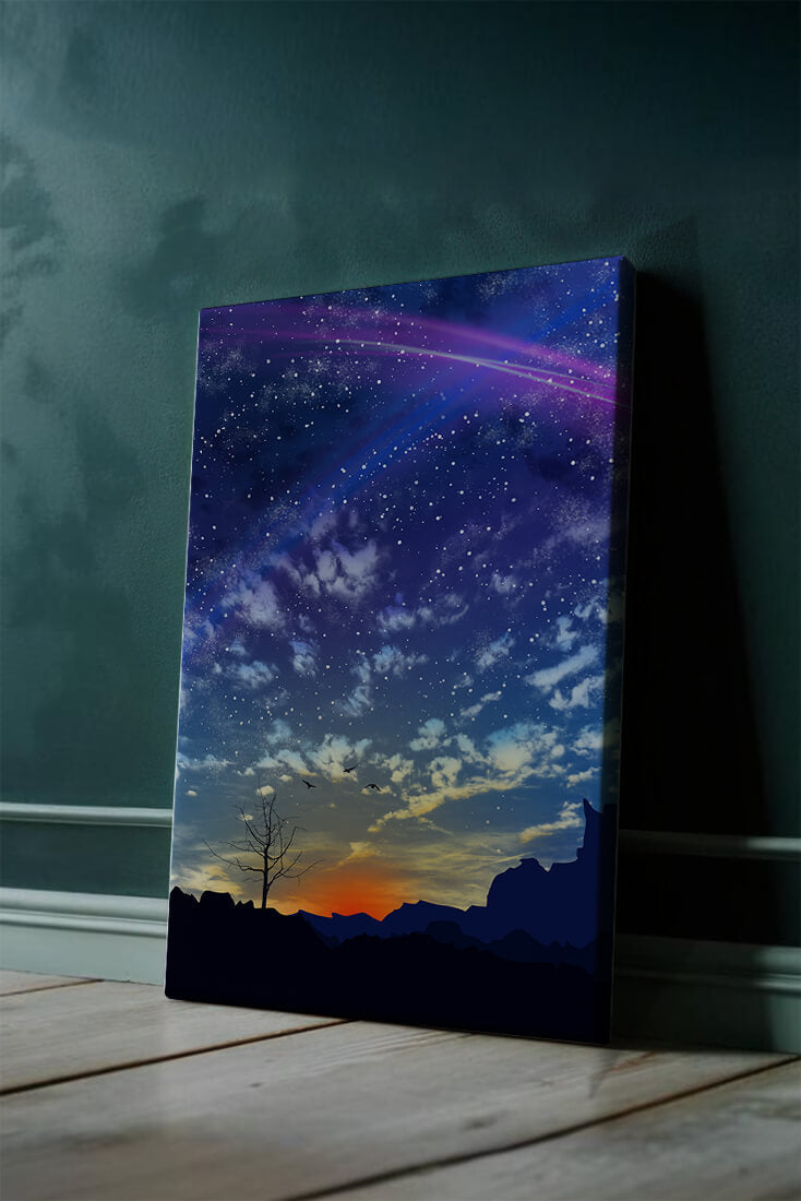 Starlit night sky with colorful sunset and silhouetted landscape