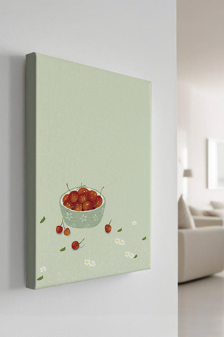 Cherries in a decorative bowl with floral accents on a soft green background