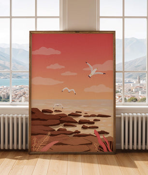Seagulls flying over rocky coastline at sunset