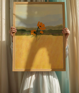 Orange Flowers in a Golden Field with Mountains and Blue Sky