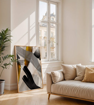 Abstract art piece with gold and black brushstrokes on a gray background