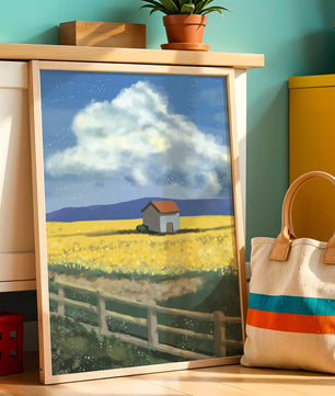 Idyllic rural scene with house and yellow field under blue sky
