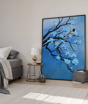 Bird on a branch with blue flowers against a snowy background
