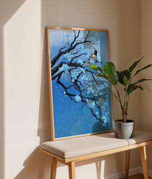 Bird on a branch with blue flowers against a snowy background
