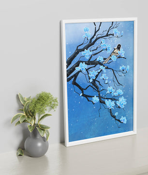 Bird on a branch with blue flowers against a snowy background