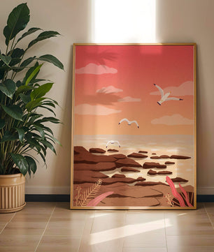Seagulls flying over rocky coastline at sunset