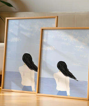 Woman gazing at the ocean with blue sky and clouds