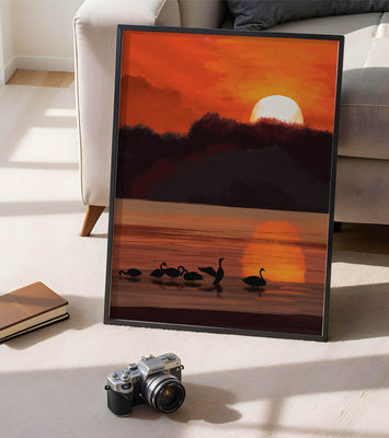 Serene sunset over a lake with silhouetted swans