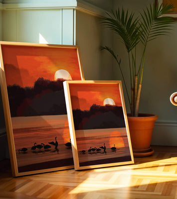 Serene sunset over a lake with silhouetted swans