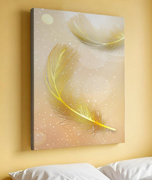Elegant golden feathers with sparkling particles on soft background