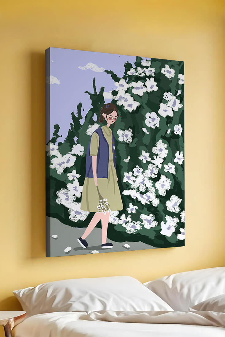 Woman walking by a lush white flower bush on a sunny day