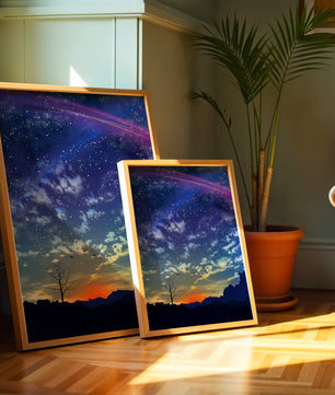 Starlit night sky with colorful sunset and silhouetted landscape