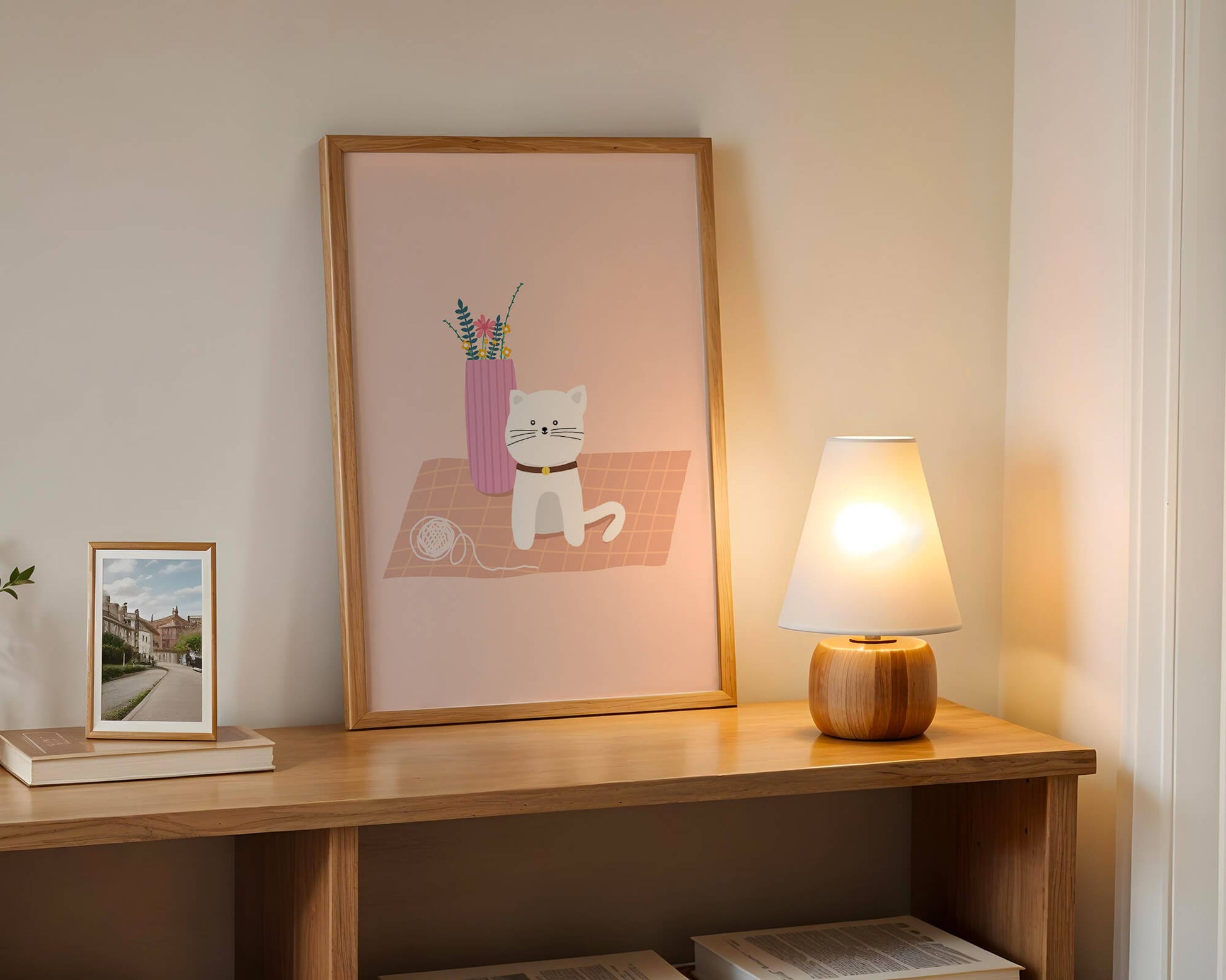 Illustration of a cute white cat with a pink vase and yarn ball on a pastel background