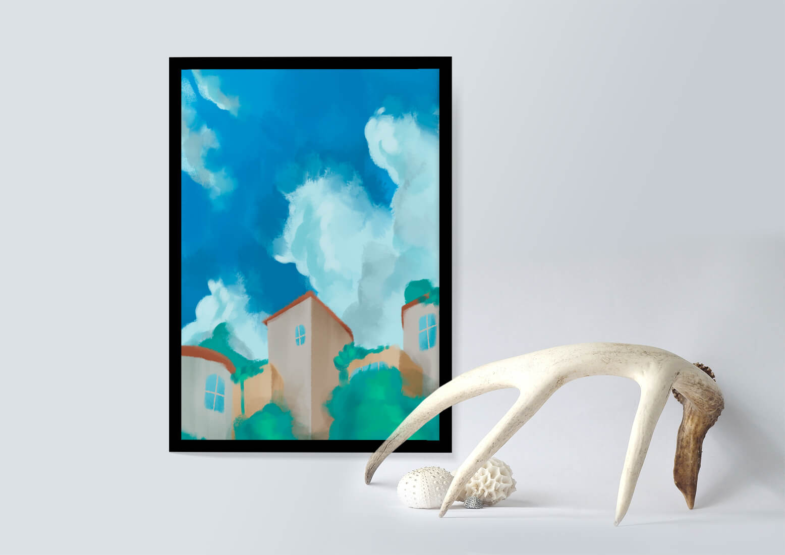 Serene landscape with houses and fluffy clouds against a blue sky