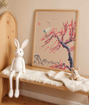 Elegant crane on cherry blossom tree with mountainous background