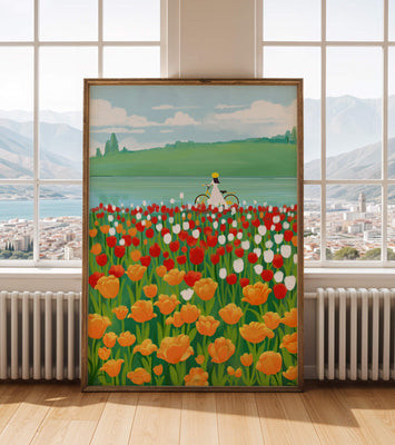 Woman with bicycle in vibrant tulip field by a lake