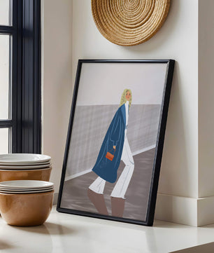 Fashionable Woman in Long Blue Coat Walking Along Corridor with Orange Handbag