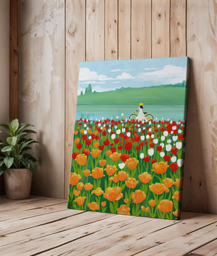 Woman with bicycle in vibrant tulip field by a lake