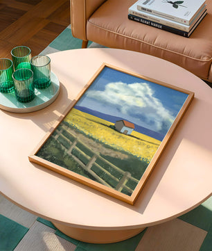 Idyllic rural scene with house and yellow field under blue sky