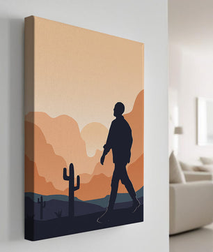Silhouetted figure walking in desert landscape at sunset
