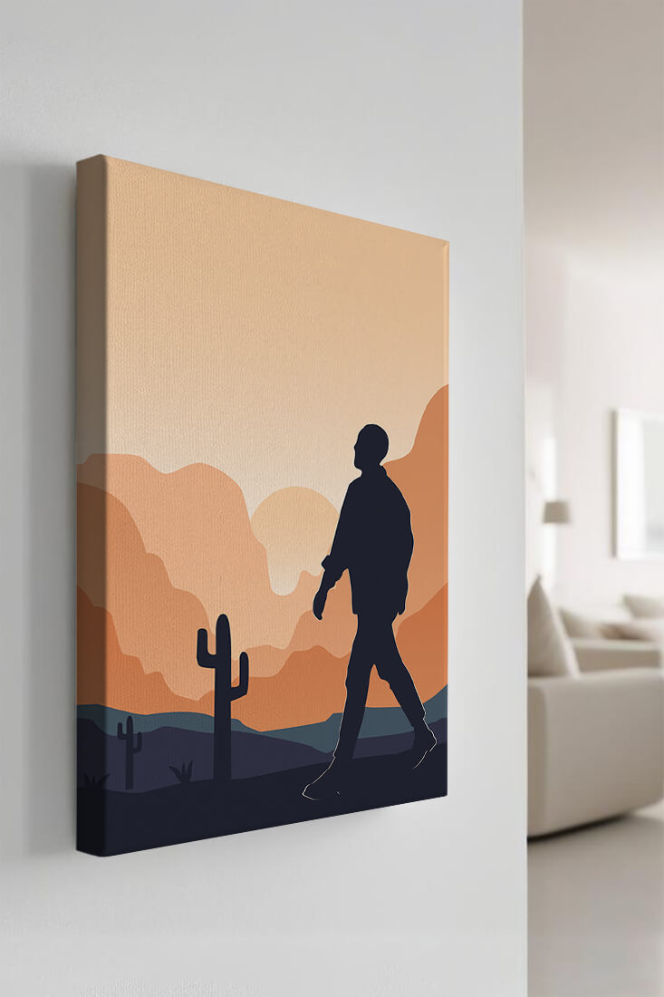 Silhouetted figure walking in desert landscape at sunset