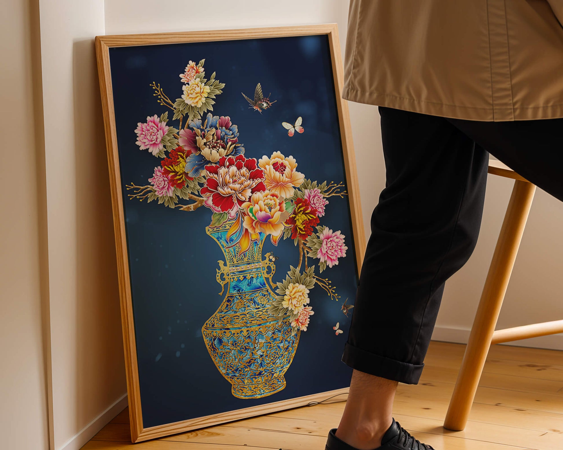 Elegant floral arrangement in ornate gold-accented vase with butterflies