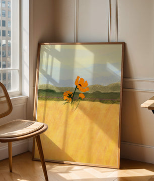Orange Flowers in a Golden Field with Mountains and Blue Sky
