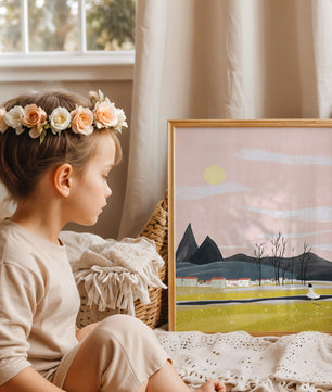 Serene landscape with mountains, village, and a girl under a pink sky